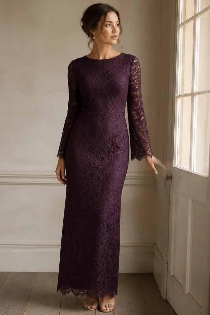 A deep plum purple long lace dress with scalloped edges on the sleeves and hem. There's a full stretch lining underneath, and the silhouette is straight with a slight waist shaping.